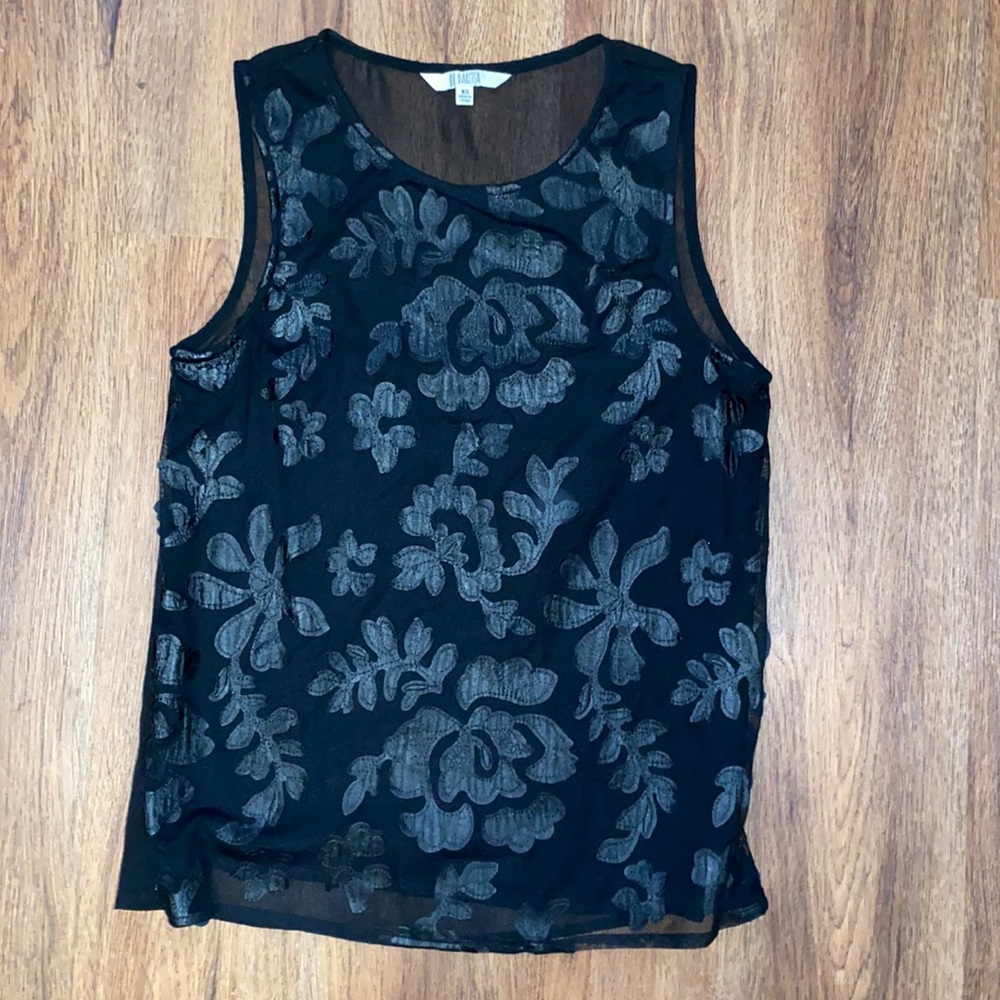 Black silk top. Floral pattern in the front.